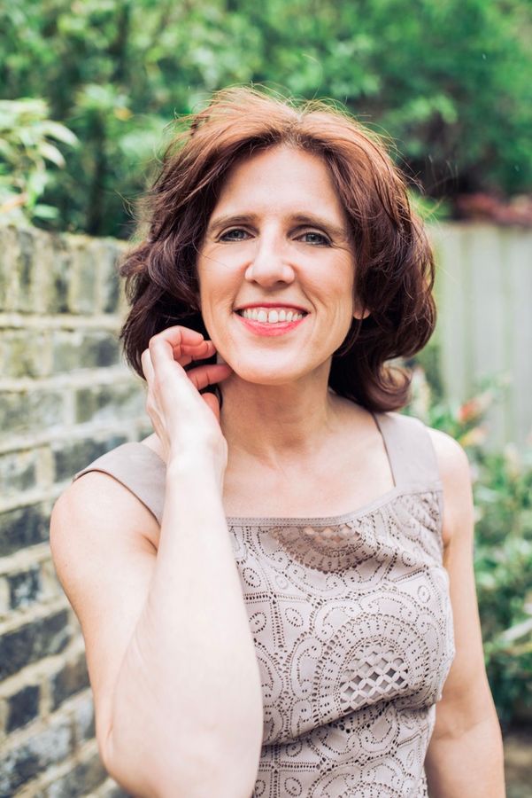Claudia smiling in a garden